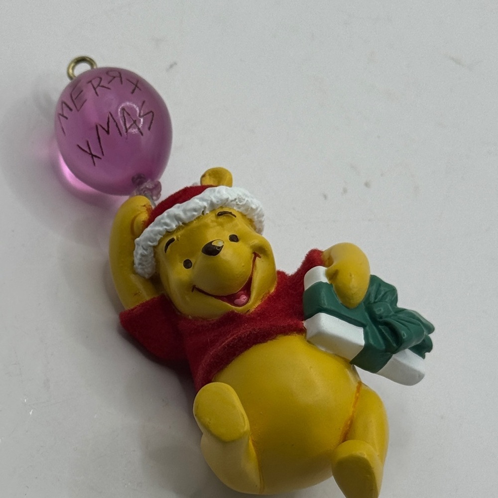 Winnie the Pooh figure ornament holding a balloon that says Merry Xmas - Picture 3 of 4